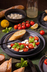 Caprese salad with fresh ingredients and baguette