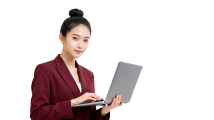Professional woman using a laptop in a business setting.