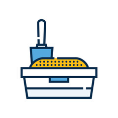 A cat litter box is filled with litter with a scoop sitting in it