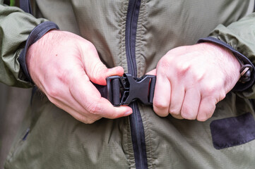 Close-Up of Man Fastening Quick-Release Buckle.