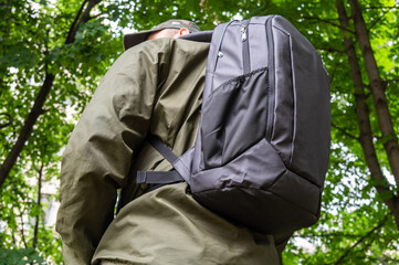 A man with a city backpack. A man and a backpack.