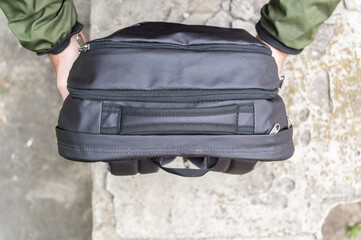 Man Handing Over Backpack to Partner. Passing the Rucksack: Teamwork and Travel Assistance.