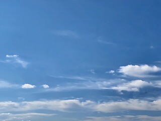 Fototapeta premium Vast blue sky with wispy white clouds and sunlight