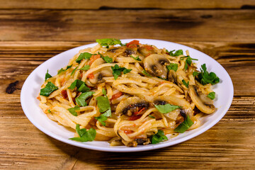 Pasta with mushrooms and tomato sauce in a plate