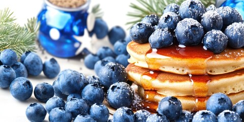 A stack of pancakes with blueberries and syrup on top. The pancakes are piled high and the blueberries are scattered all over the pancakes
