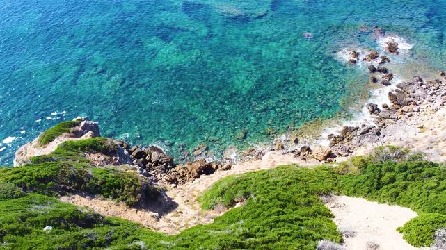 Aerial view of turquoise water and green vegetation in Sardinia