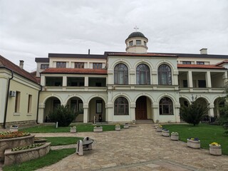 Orthodox monastery residence with arched facade and courtyard