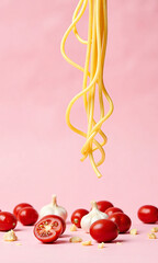 lone strand spaghetti twirls air amidst scattering cherry tomatoes minced garlic soft pastel pink