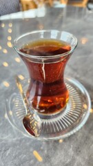 Turkish style brewed tea in a thin waisted glass cup