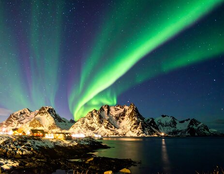 Night view of green and blue lights over snow-capped mountains - Powered by Adobe