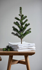 rfectly lit green christmas tree branch atop pile crisp white paper scattered pine branches soft muted gray