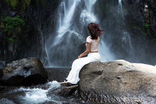 Woman at Gitgit waterfall in Singaraja, Bali, Indonesia