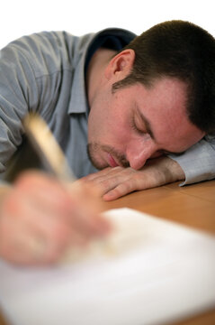Tired man fallen asleep while writing