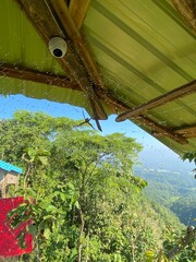 hills with beautiful clouds in the morning. Summer Mountain with green plants and clouds in the sky. wooden hut on Mountain. Texture of green tree forest view from above, Beautiful sunrise.