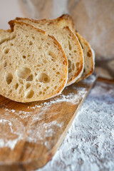 Bread, traditional sourdough, homemade sourdough bread cut into slices on a rustic wooden cutting...