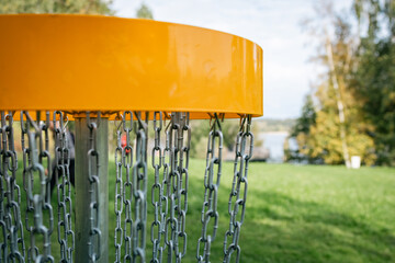 yellow discgolf basket on the course