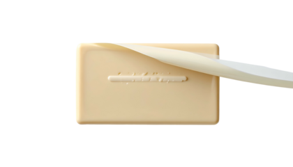 A beige rectangular bar with a peeling white top layer against a black backdrop