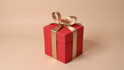 Red gift box with golden ribbon on a soft pink background