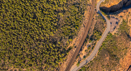 Panoramic aerial view of Esterel Mountains coastline with winding coastal road and railway tracks above the Mediterranean Sea, French Riviera, Southern France, scenic cliffs and ocean