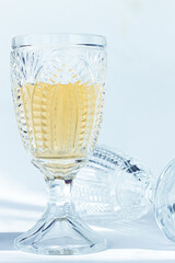 Crystal glass filled with white wine, elegant design, in a bright environment, close-up, selective focus, no people,