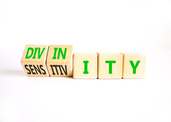 Sensitivity or divinity symbol. Concept words Sensitivity or Divinity on wooden cubes. Beautiful...