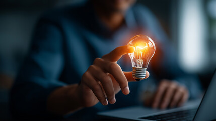 Business hand pointing at video analytics with lightbulb engagement insight creative performance optimization digital video strategy view counts and metrics laptop defocused