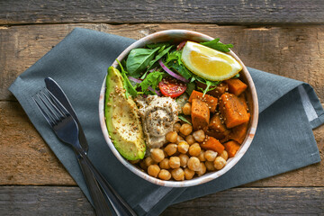 Bowl of chickpeas, salad, sweet potato, salad and avocado