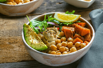 Bowl of chickpeas, salad, sweet potato, salad and avocado