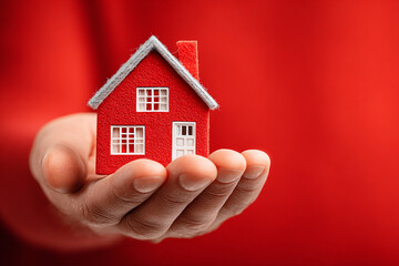 Illustration of home insurance protection — safe home symbol, coverage concept, and risk prevention. Red background for contrast and emphasis.