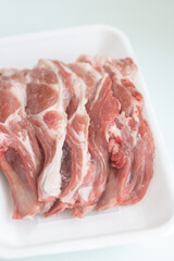 Raw Chops with Garlic and Spices on a Wooden Plate