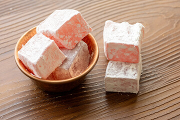 Assorted Turkish Delights in a Copper Bowl on a Wooden Table (Close-Up)
