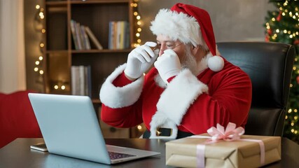 Jolly Santa Claus video chatting online with laptop, spreading holiday cheer and connecting with loved ones during festive season, gifting inspiration