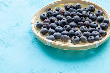 Close-Up of Wild Blueberries in a Wooden Bowl
