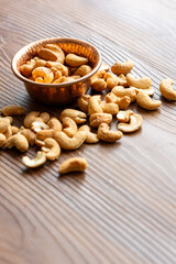 Close-Up of Cashews in a Copper Bowl on a Wooden Surface
