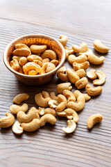 Close-Up of Cashews in a Copper Bowl on a Wooden Surface
