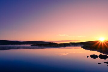 Golden Mist Over Tranquil Lake at Sunrise