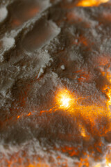 Warm glowing sand texture with orange light background, abstract macro natural pattern