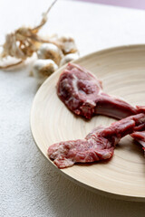 Raw Chops with Garlic and Spices on a Wooden Plate
