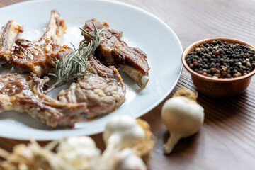 Garlic and Herb Crusted Chops on a White Plate on a Wooden Table
