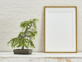 Mock up poster frame on white plaster wall with bonsai tree on old wooden table; portrait orientation; stylish frame mock up; 3d rendering, 3d illustration