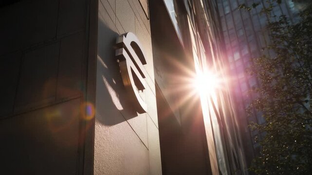 Euro currency symbol on modern building wall with sunlight reflection concept of finance banking and economy in Europe