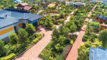 Fototapeta premium Aerial view of a vibrant park with walking paths, lush greenery, and playgrounds bustling with activity