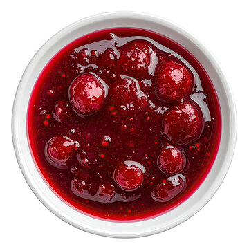 Overhead view of a white bowl filled with vibrant red berry sauce and whole fruits