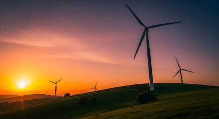 Obraz premium Wind turbines on a green hill against a vibrant sunset sky generating renewable energy source view
