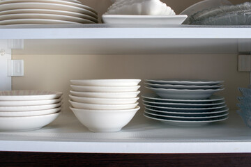 Dish rack in a kitchen cabinet. Close-up.