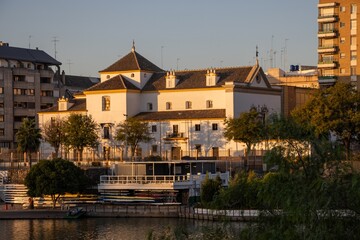 Instituto Hispano-Cubano de Historia de América in Seville during sunrise over the river.