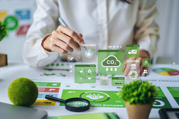 Business professional reviews ESG data report for corporate sustainability strategy environmental impact analysis at carbon icon modern office desk