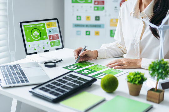 Business professional analyzes ESG data plans sustainable development strategy promotes green economy future office environment - Powered by Adobe
