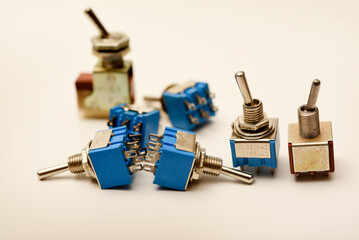 Small electric switches. Electric toggle switch. Blue switches.