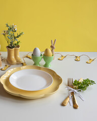 Happy Easter. Easter celebration concept. Top view vertical empty white and yellow plate, Easter eggs, on isolated white background. Copy space, place for text, banner.